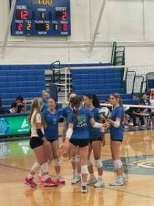 Members of the volleyball team huddle on the court during their section win vs. North on Oct. 23