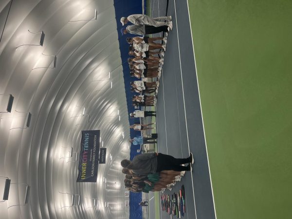 Girls' Tennis Team (white) lining up and meeting their opponent, Litchfield, in the Class A state tennis tournament championship at the InnerCity Tennis Center in Minneapolis. 