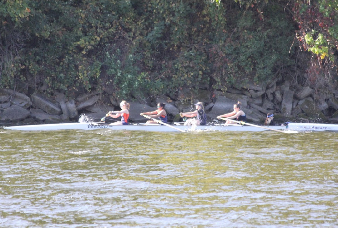 Newberry (second from right) rowing on the Mississippi River.