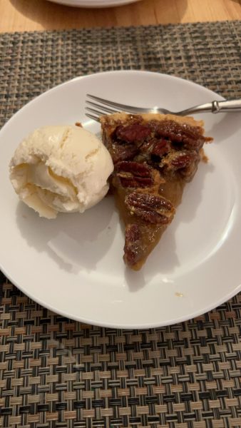 Warm pecan pie with ice cream is a tasty dessert for Thanksgiving