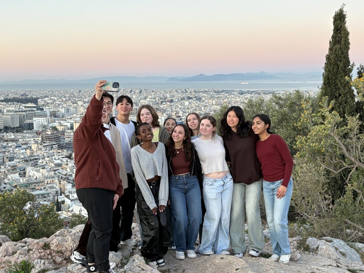 Natalia Romero Arbeláez, Macaella Sikohya ‘25, Gabi Marmet ‘25, Anna Craig ‘25, Catherine Lin ‘25, Aanya Pandey ‘25, (Front L-R), Alan Hodder ‘25, Capistrant, Alena Bohrensen ‘25, Wyatt, Broll (Back L-R) on a sunset hike overlooking the city of Athens.